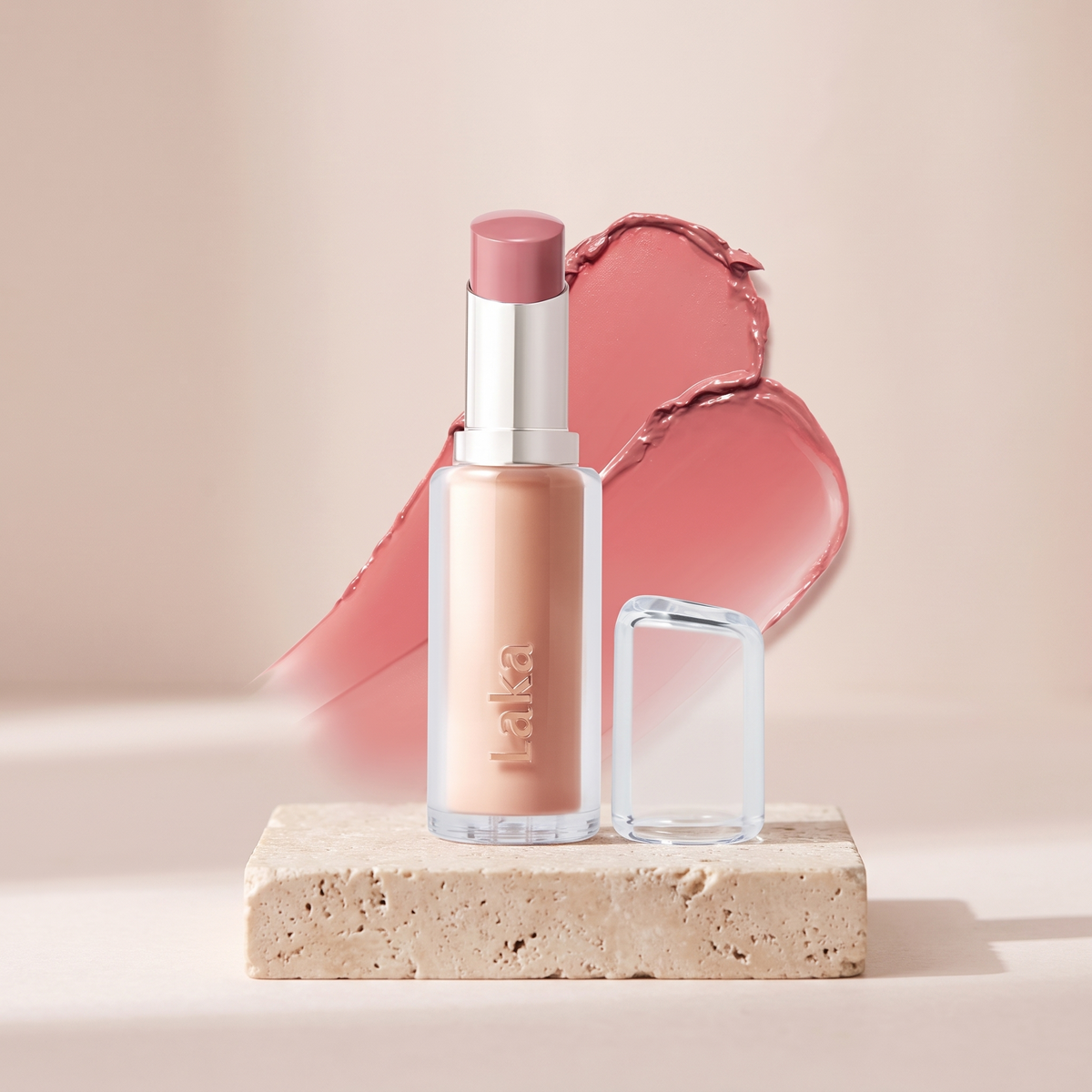 Laka 24HR Bonding Glow Lipstick styled on travertine pedestal, blush studio