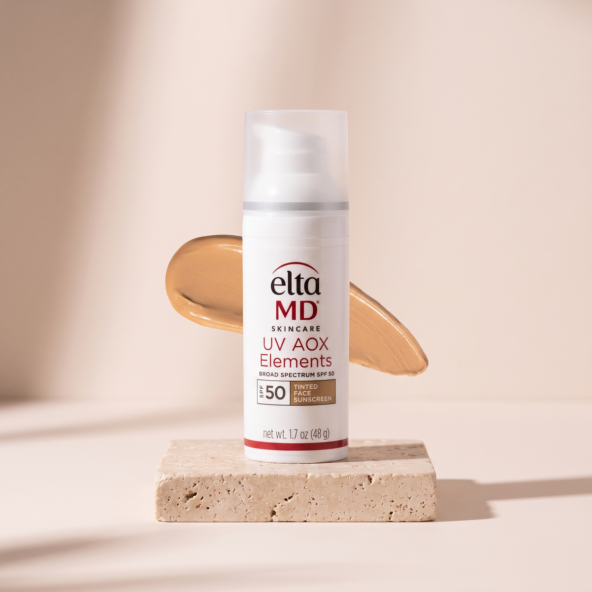 EltaMD UV Elements Tinted Sunscreen SPF 44 styled on travertine pedestal, blush studio