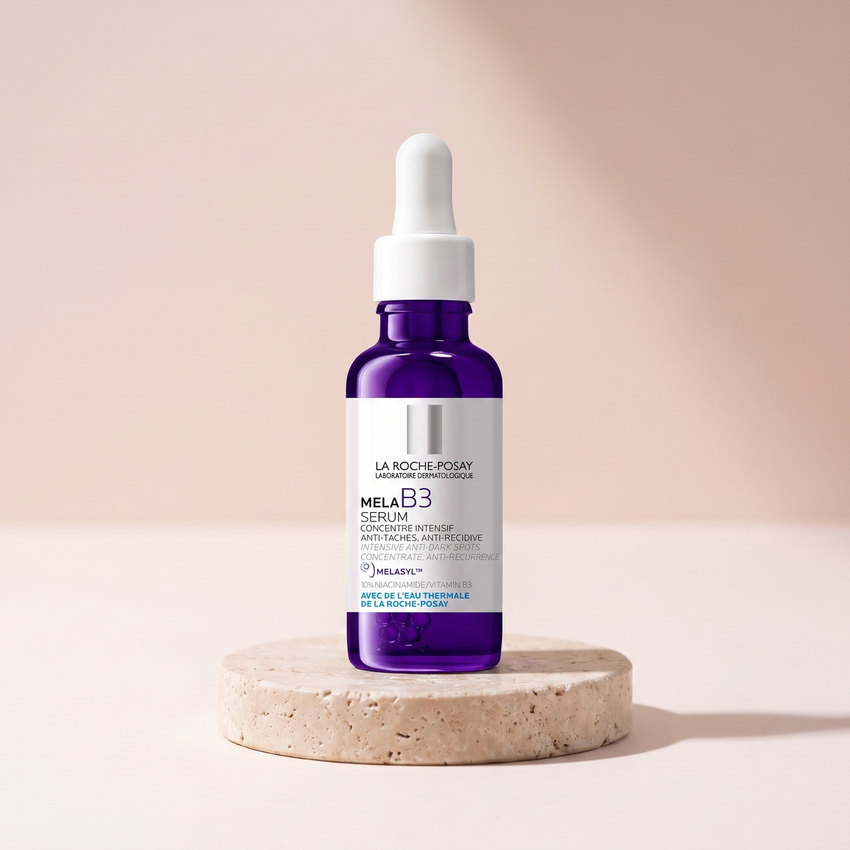La Roche-Posay Mela B3 Serum styled on travertine pedestal, blush studio