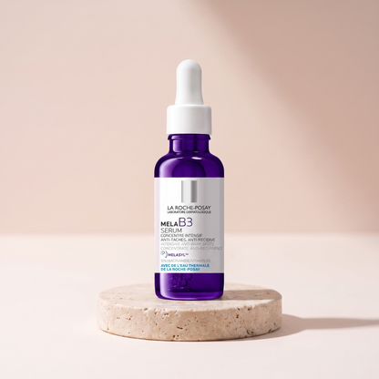 La Roche-Posay Mela B3 Serum styled on travertine pedestal, blush studio
