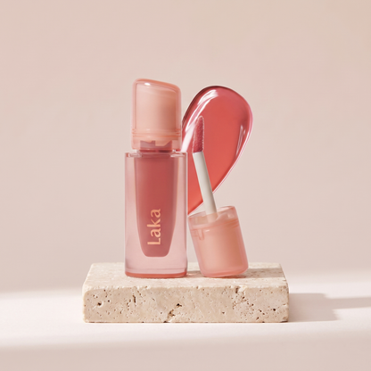 Laka Jelling Nude Gloss styled on travertine pedestal, blush studio