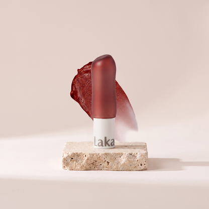 Laka Soul Vegan Tinted Lip Balm styled on travertine pedestal, blush studio