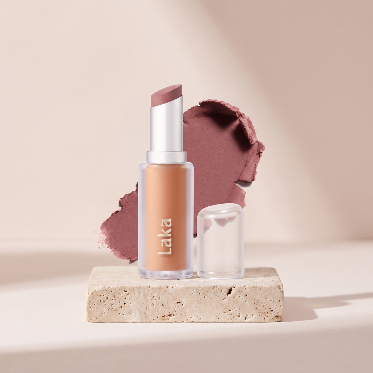 Laka Bulky Matte Lipstick styled on travertine pedestal, blush studio