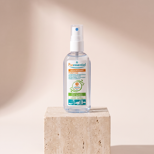 Puressentiel Antibacterial Lotion Spray 2.7 oz styled on travertine pedestal, blush studio