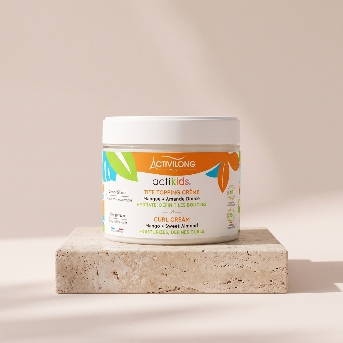 Activilong Actikids Tite Topping Curl Cream 300 ml styled on travertine pedestal, blush studio