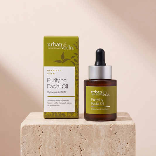 Urban Veda Purifying Facial Oil 30 ml styled on travertine pedestal, blush studio