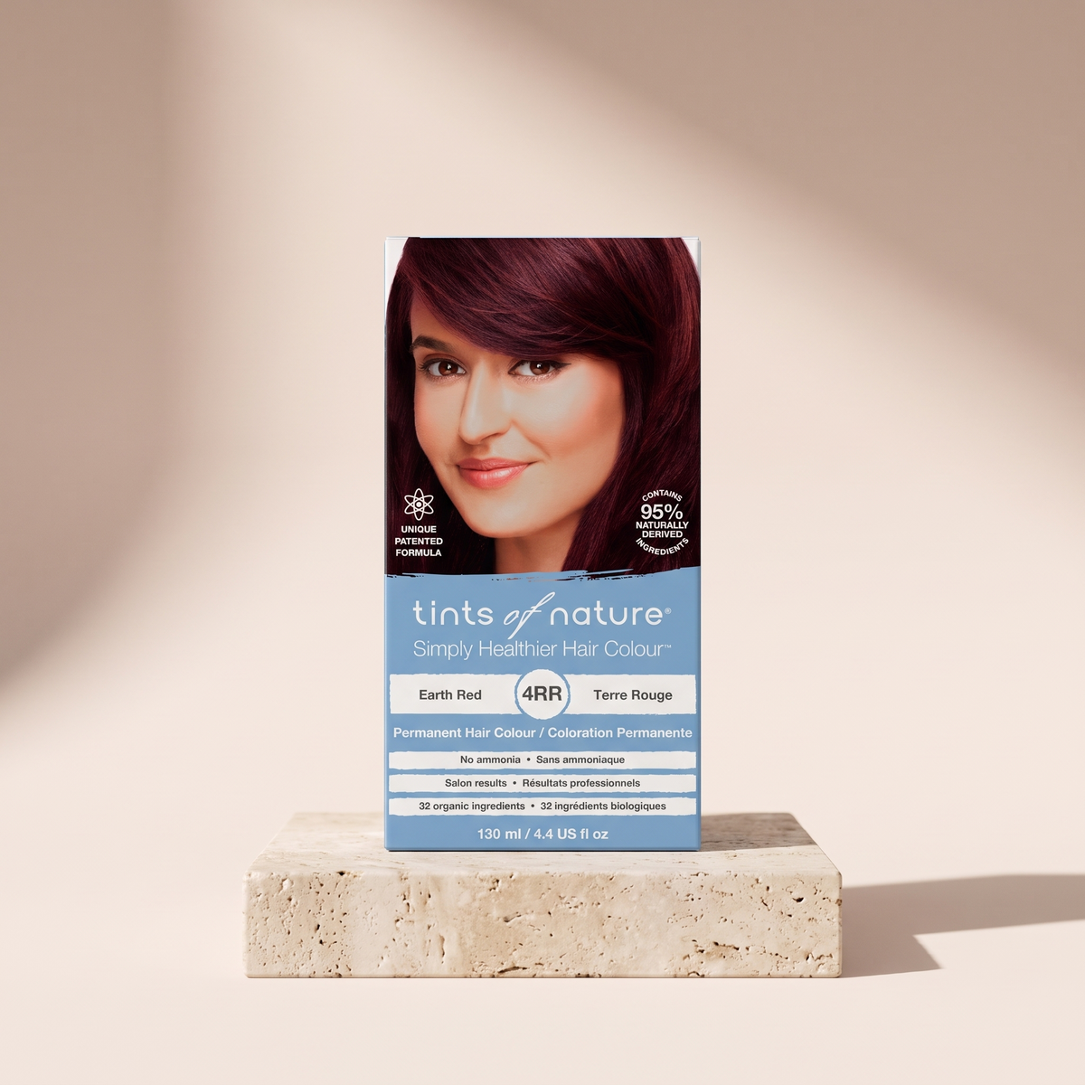 Tints of Nature Organic 4RR Earth Red Permanent Hair Colour styled on travertine pedestal, blush studio