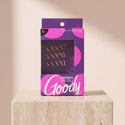 Goody Simple Styles Mini Spin Pins Blonde 3-Pack styled on travertine pedestal, blush studio