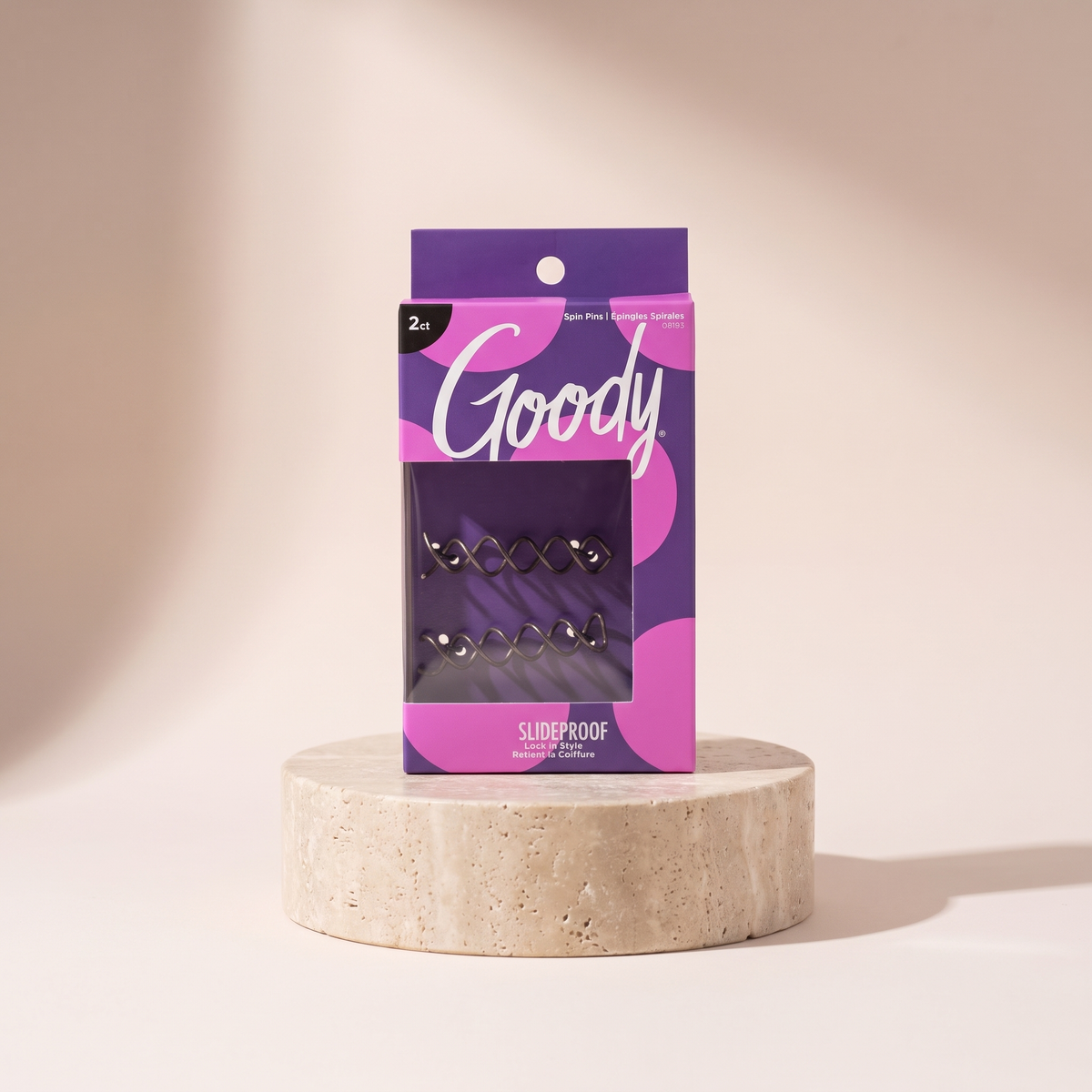 Goody Simple Styles Hair Spin Pin Coil Blonde 2-Pack styled on travertine pedestal, blush studio