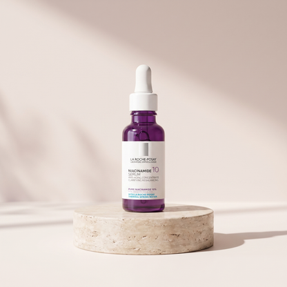 PURE Niacinamide 10 Serum 30 ml styled on travertine pedestal, blush studio