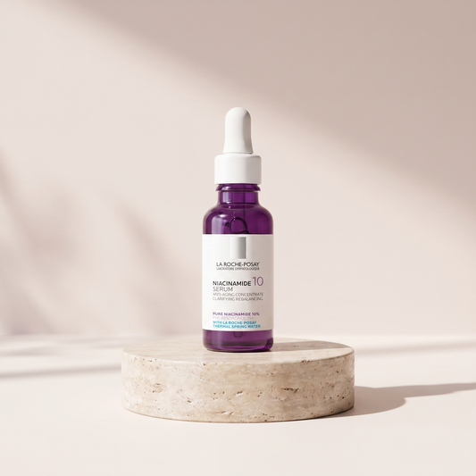 PURE Niacinamide 10 Serum 30 ml styled on travertine pedestal, blush studio