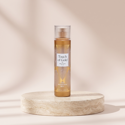 Bath and Body Works Touch of Gold Fine Fragrance Mist 236 ml styled on travertine pedestal, blush studio
