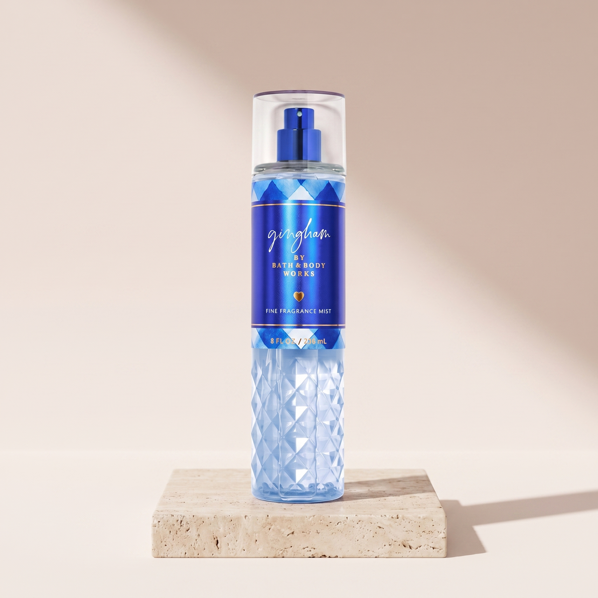 Bath and Body Works Gingham Fine Fragrance Mist 236 ml styled on travertine pedestal, blush studio