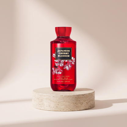 Bath and Body Works Japanese Cherry Blossom Body Wash 295 ml styled on travertine pedestal, blush studio