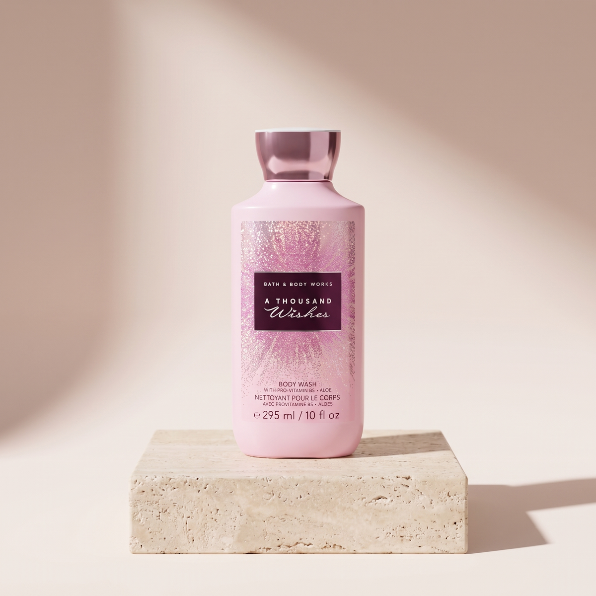 Bath and Body Works A Thousand Wishes Body Wash 295 ml styled on travertine pedestal, blush studio