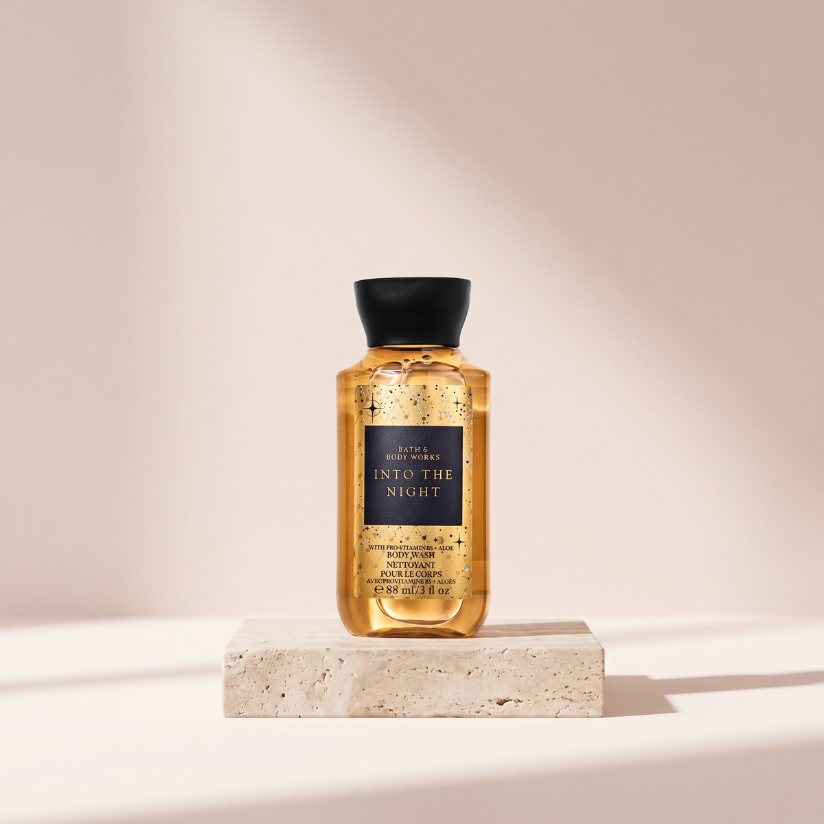 Bath and Body Works Into the Night Body Wash 295 ml styled on travertine pedestal, blush studio