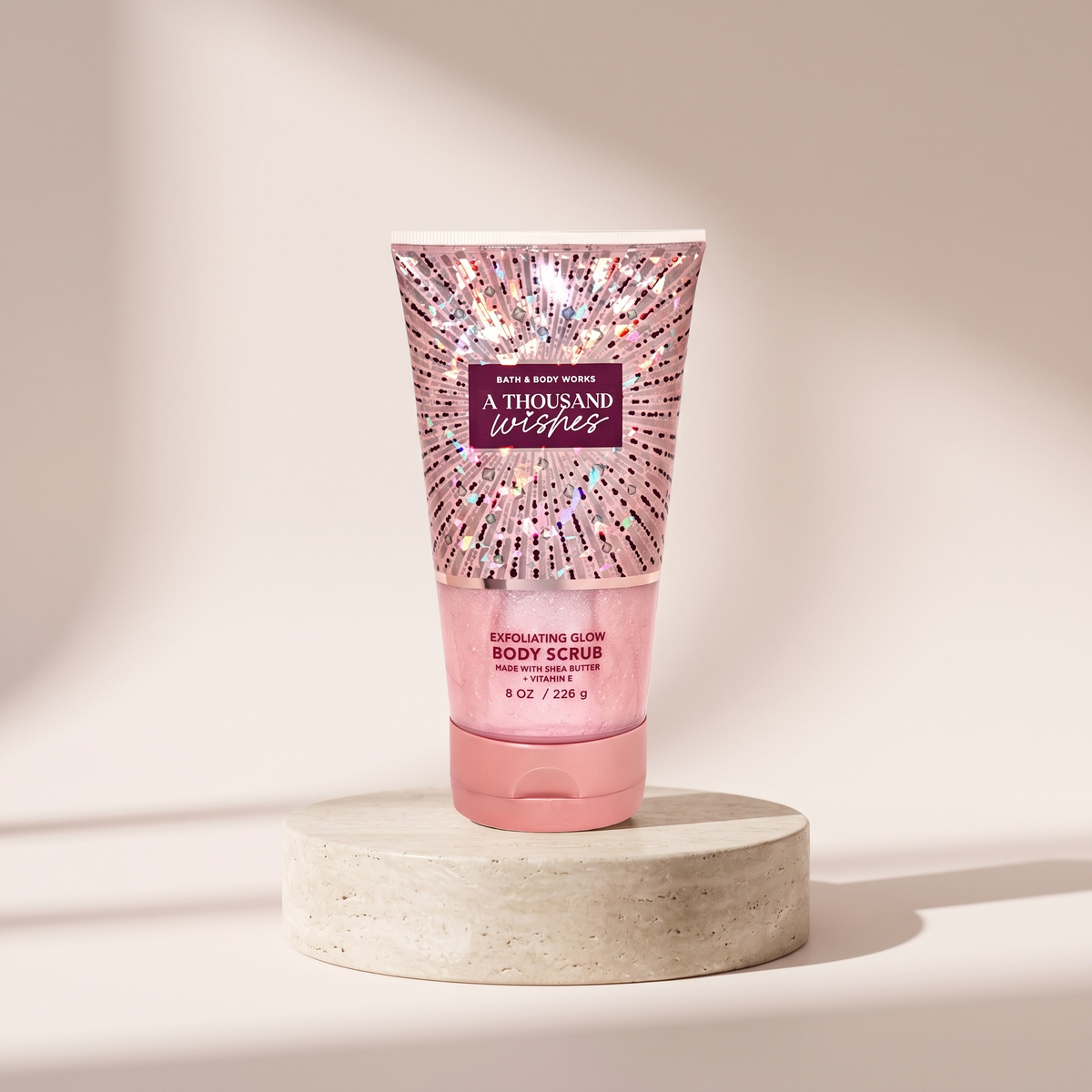 Bath and Body Works Body Scrub A Thousand Wishes 8 oz styled on travertine pedestal, blush studio