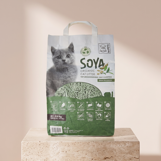 M-Pets Soya Organic Cat Litter Green Tea Scented 6 L styled on travertine pedestal, blush studio