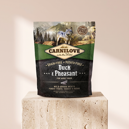 Carnilove Duck and Pheasant Dry Dog Food 1.5 kg styled on travertine pedestal, blush studio