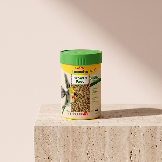 Sera ImmunPro Nature probiotic growth food styled on travertine pedestal, blush studio