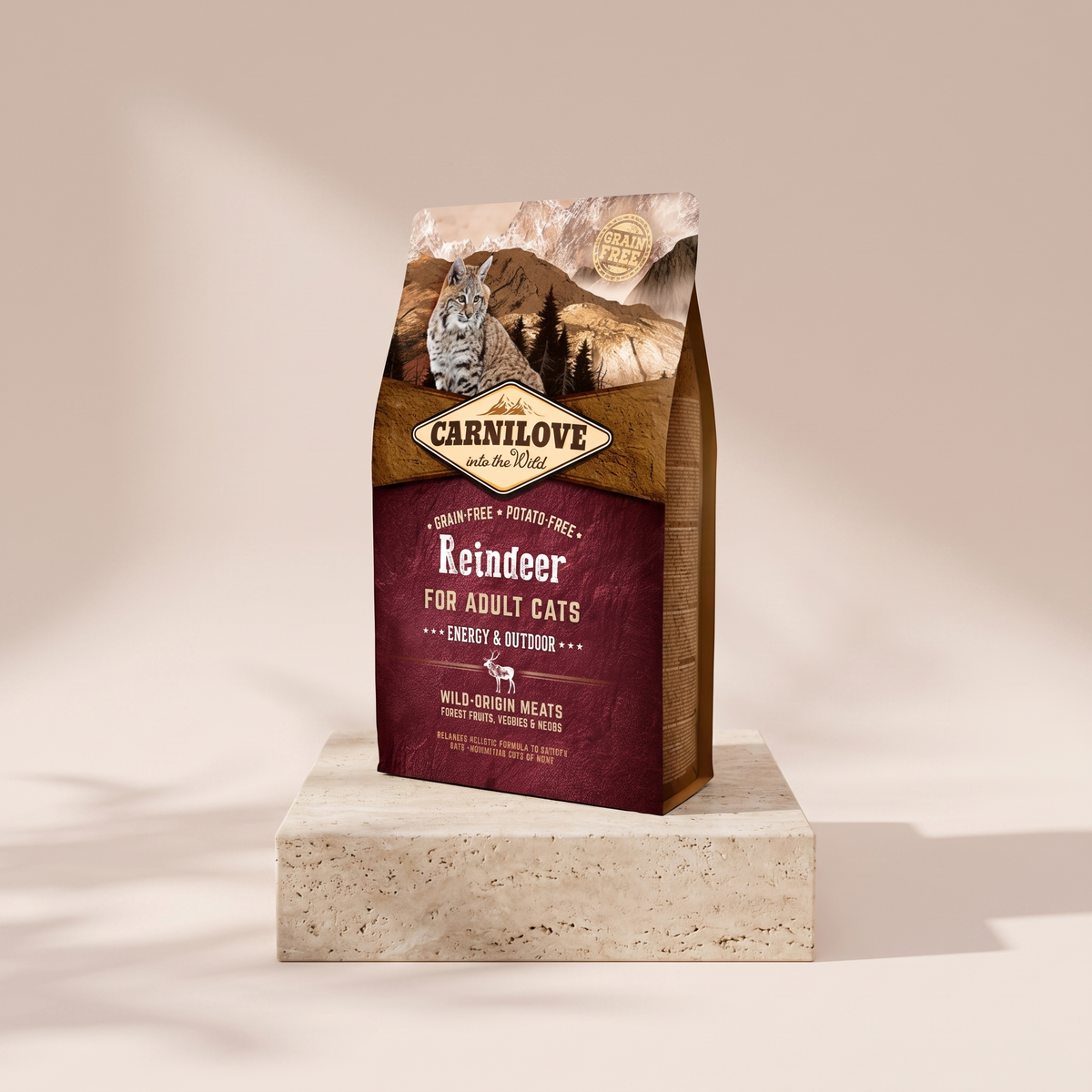 Carnilove Reindeer Dry Food for Adult Cats 2 kg styled on travertine pedestal, blush studio
