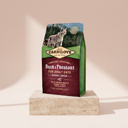Carnilove Duck and Pheasant Adult Hairball Cat Food styled on travertine pedestal, blush studio