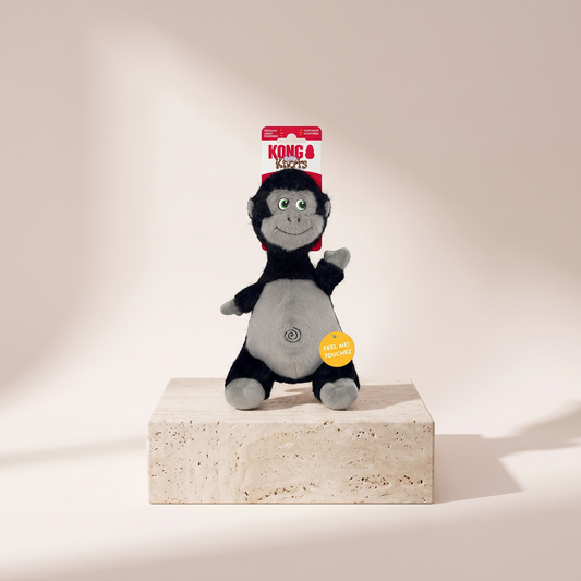 KONG Knots Belly Gorilla plush dog toy styled on travertine pedestal, blush studio