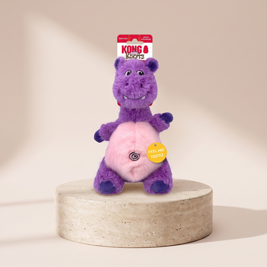 KONG Knots Belly Hippo plush dog toy styled on travertine pedestal, blush studio