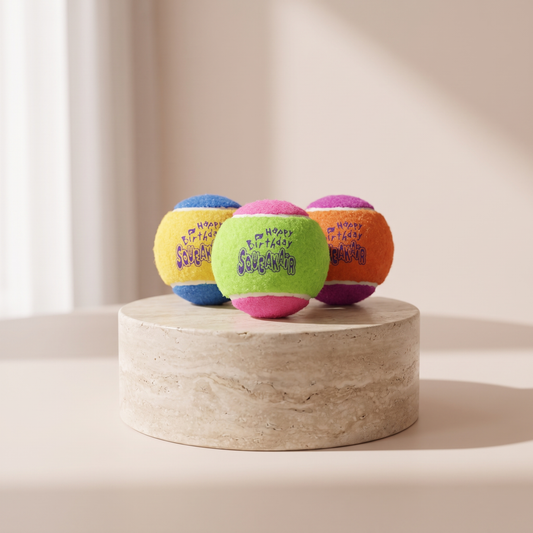 KONG Birthday SqueakAir Balls medium styled on travertine pedestal, blush studio
