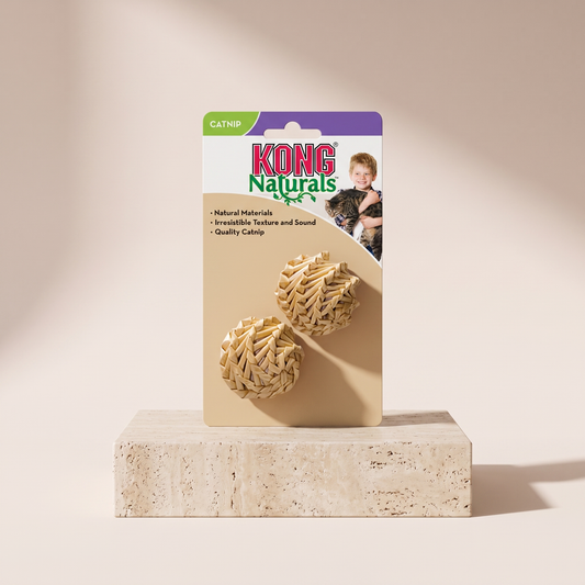 KONG Straw Ball natural fiber cat toy styled on travertine pedestal, blush studio